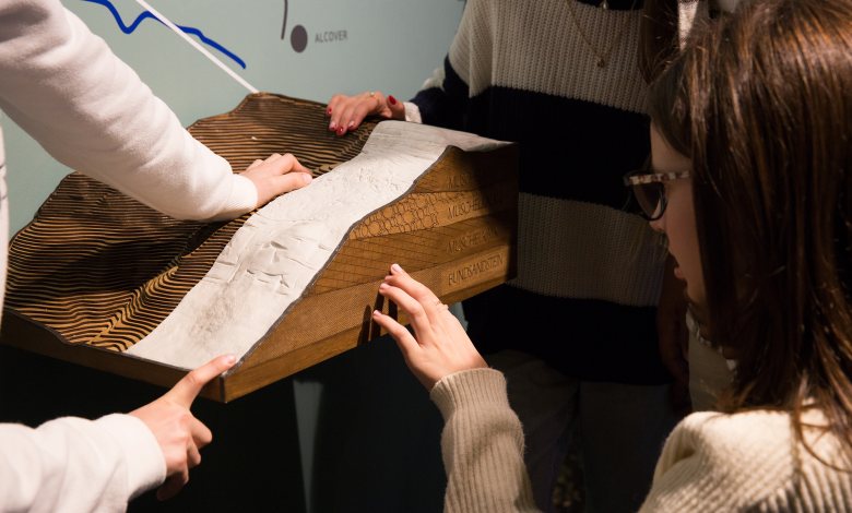 Persones tocant una maqueta