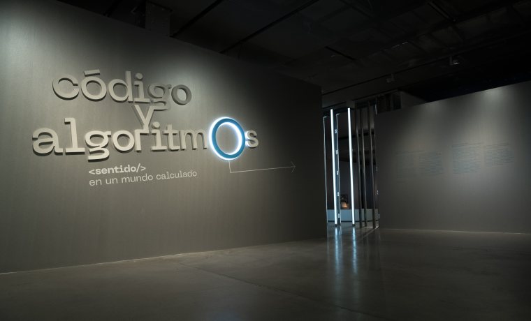 Fotografía de la primera sala de la exposición con el título Código y algoritmos escrito en grande.